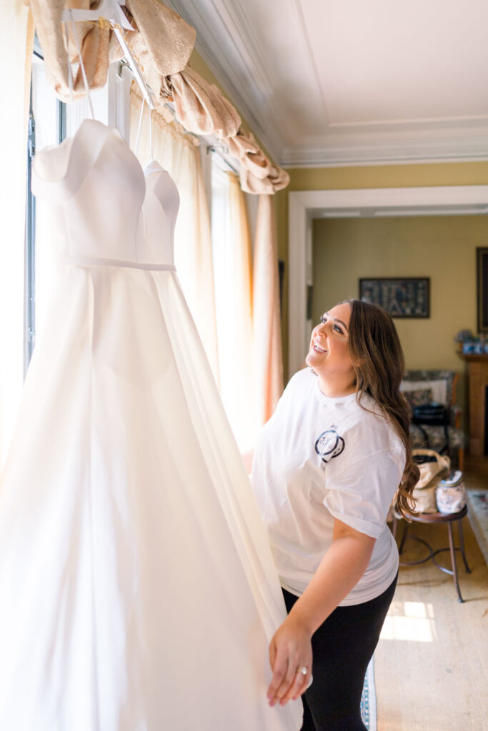 bride looking at her wedding dress at bridal seamstress shop in Olympia, WA