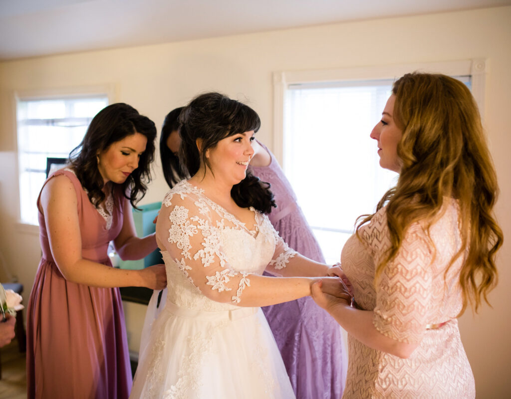 A bride wearing her altered dress during her wedding.