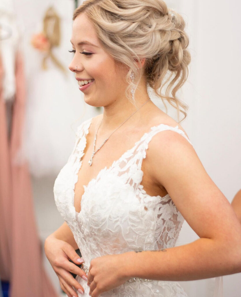 Bride looking at her gown during preparation